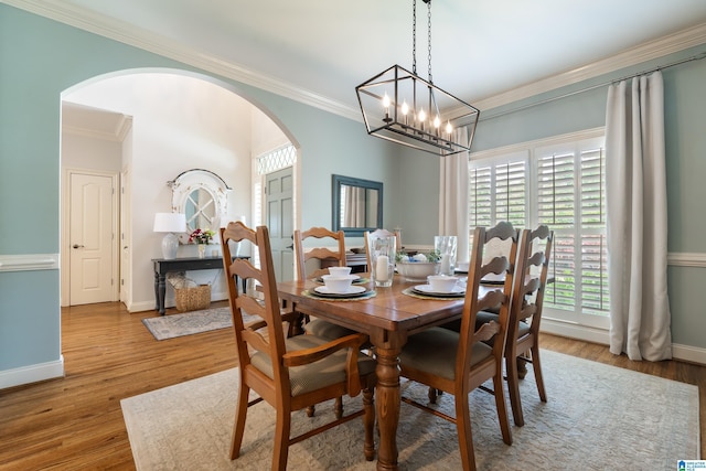 1048 Eagle Hollow Dr, Birmingham, AL 35242 - dining room with arched walkways, crown molding, wood finished floors, and baseboards