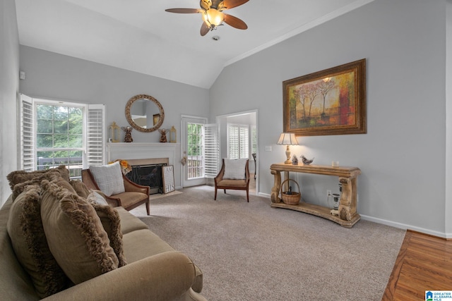 126 Landale Dr, Sterrett, AL 35147 - living area with a ceiling fan, vaulted ceiling, baseboards, a fireplace with flush hearth, and crown molding