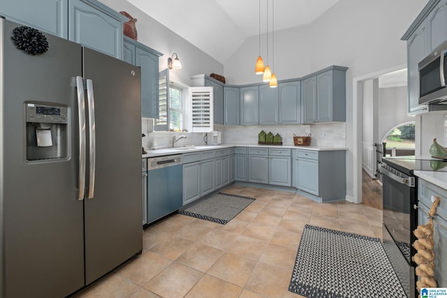 126 Landale Dr, Sterrett, AL 35147 - kitchen with appliances with stainless steel finishes, decorative backsplash, light countertops, vaulted ceiling, and pendant lighting