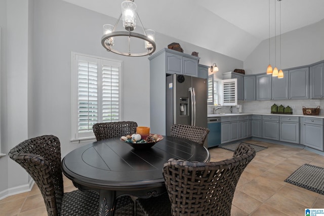 126 Landale Dr, Sterrett, AL 35147 - dining area with vaulted ceiling, a chandelier, and light tile patterned floors