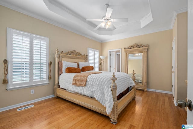 126 Landale Dr, Sterrett, AL 35147 - bedroom featuring a raised ceiling, crown molding, baseboards, light wood-style floors, and a ceiling fan