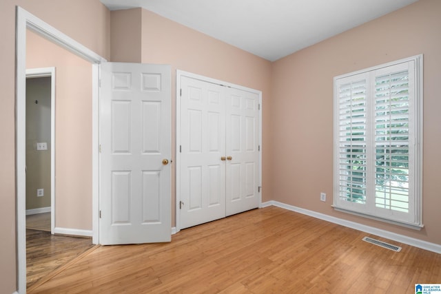 126 Landale Dr, Sterrett, AL 35147 - unfurnished bedroom with light wood finished floors, baseboards, and a closet