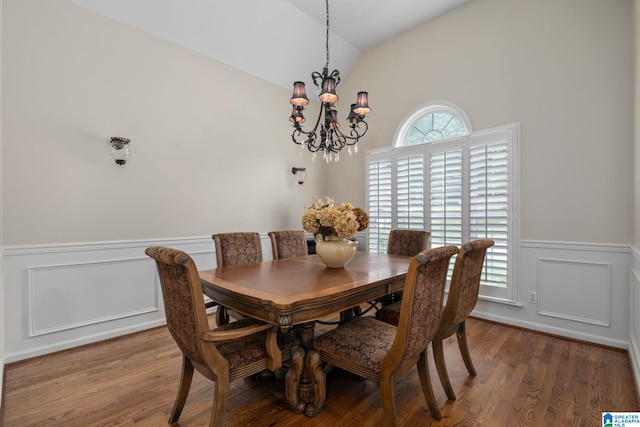 126 Landale Dr, Sterrett, AL 35147 - dining room with a chandelier, wood finished floors, vaulted ceiling, wainscoting, and a decorative wall