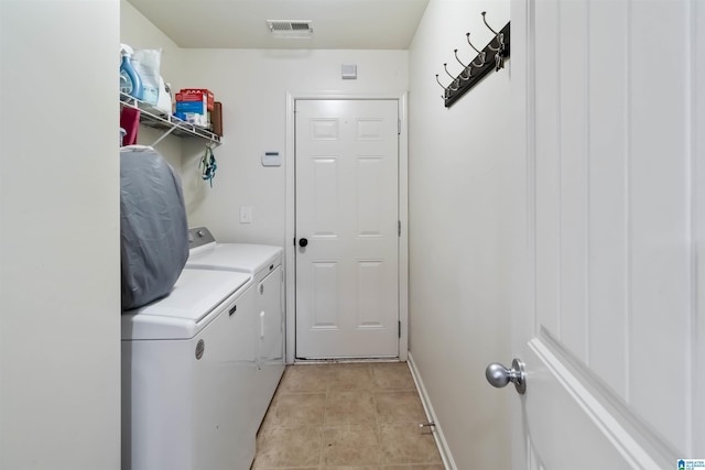 22873 Downing Park Cir, Mccalla, AL 35111 - laundry area featuring washer and dryer and light tile patterned floors