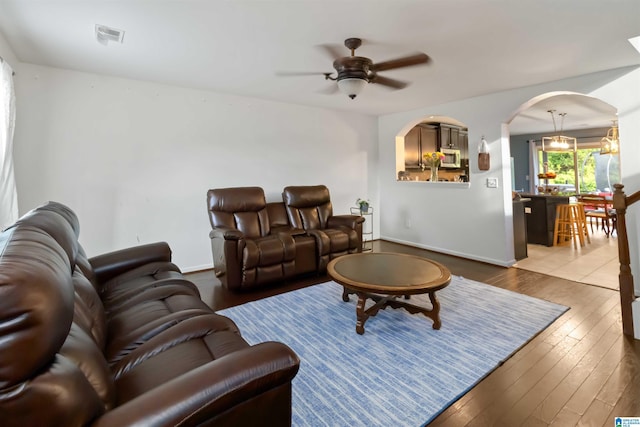 22873 Downing Park Cir, Mccalla, AL 35111 - living area with arched walkways, ceiling fan, hardwood / wood-style flooring, and baseboards