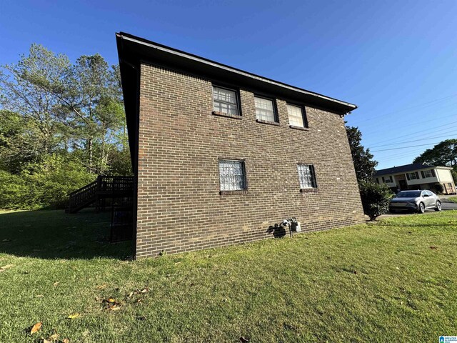 2270 Smithfield Ln N, Birmingham, AL 35207 - view of home's exterior with a lawn, brick siding, and stairway