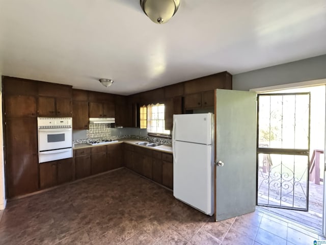 2270 Smithfield Ln N, Birmingham, AL 35207 - kitchen featuring white appliances, a warming drawer, under cabinet range hood, dark brown cabinets, and a sink