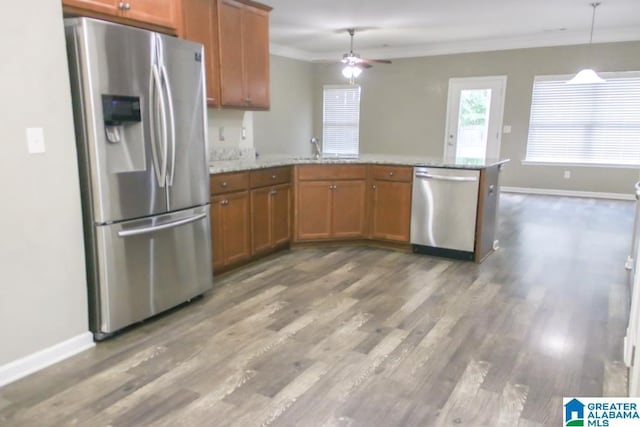 4905 Stonecreek Way, Calera, AL 35040 - kitchen with stainless steel appliances, brown cabinets, a peninsula, crown molding, and ceiling fan