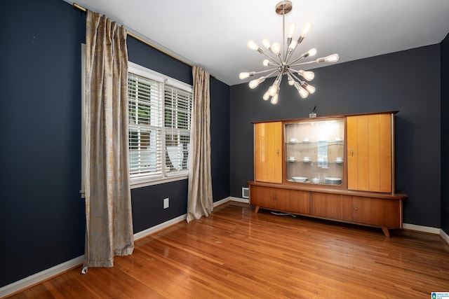 400 Art Hanes Blvd, Birmingham, AL 35213 - unfurnished dining area with a chandelier, wood finished floors, and baseboards