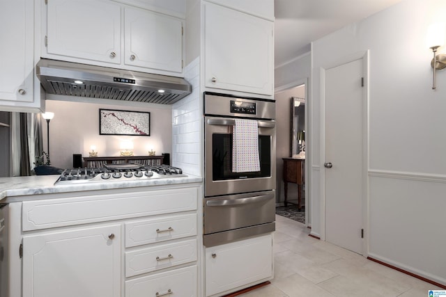 400 Art Hanes Blvd, Birmingham, AL 35213 - kitchen featuring appliances with stainless steel finishes, a warming drawer, under cabinet range hood, and white cabinetry