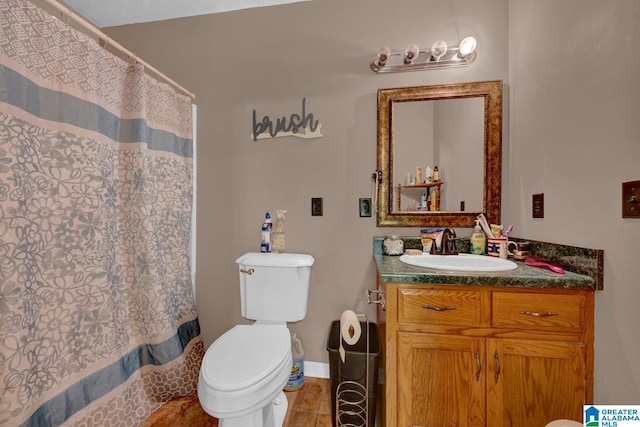 85 County Road 738, Cullman, AL 35055 - bathroom with vanity, toilet, tile patterned flooring, a shower with curtain, and baseboards