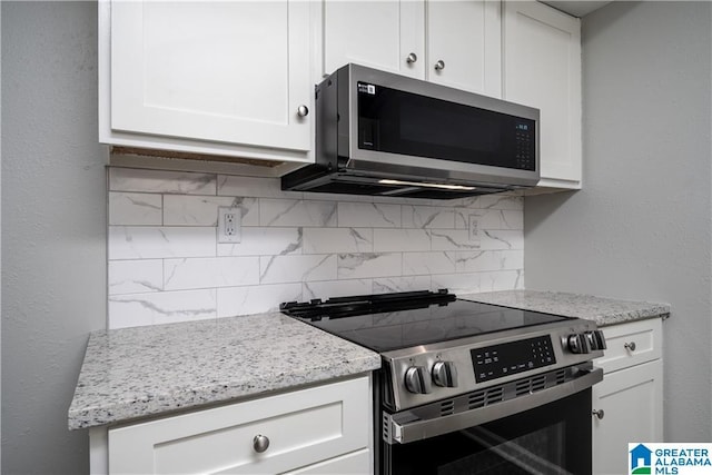 1721 Hackberry Ln Unit 6, Tuscaloosa, AL 35401 - kitchen with stainless steel appliances, backsplash, white cabinetry, and light stone countertops