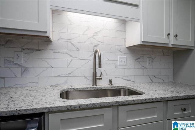1721 Hackberry Ln Unit 6, Tuscaloosa, AL 35401 - kitchen featuring backsplash, light stone countertops, and white cabinets