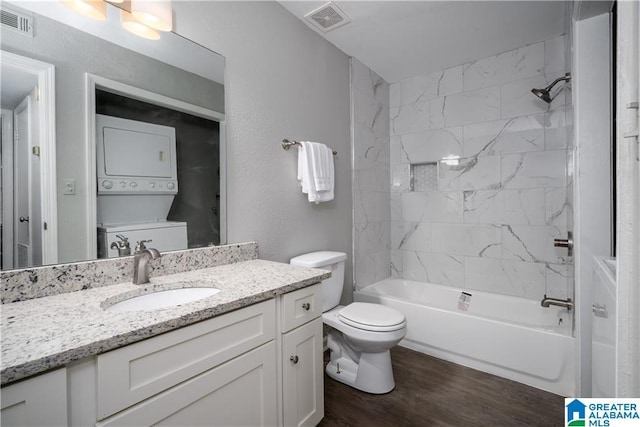 1721 Hackberry Ln Unit 6, Tuscaloosa, AL 35401 - bathroom with stacked washer / drying machine, vanity, tub / shower combination, and wood finished floors