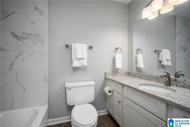 1721 Hackberry Ln Unit 6, Tuscaloosa, AL 35401 - bathroom featuring vanity, wood finished floors, and bathing tub / shower combination