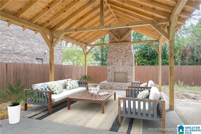 1721 Hackberry Ln Unit 6, Tuscaloosa, AL 35401 - fenced backyard with an outdoor living space with a fireplace and a patio