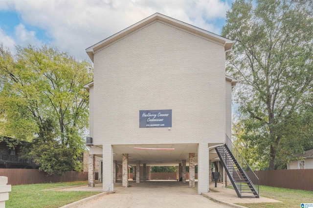 1721 Hackberry Ln Unit 6, Tuscaloosa, AL 35401 - view of building exterior with a carport, stairs, and concrete driveway