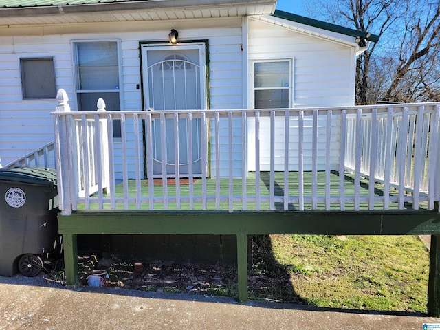 view of exterior entry featuring metal roof and a deck