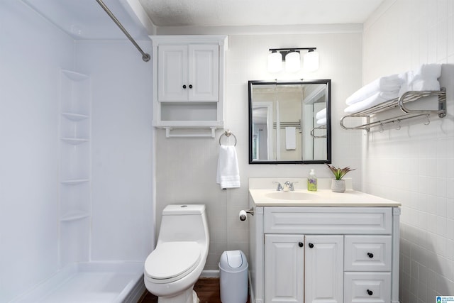 1800 2nd Ave S, Irondale, AL 35210 - bathroom featuring tile walls, a shower, vanity, and toilet