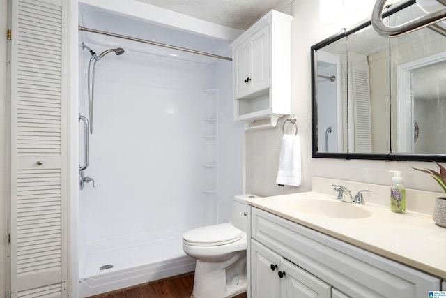 1800 2nd Ave S, Irondale, AL 35210 - bathroom featuring a closet, vanity, a stall shower, and toilet