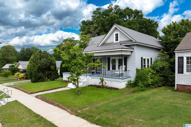 1800 2nd Ave S, Irondale, AL 35210 - view of front facade featuring covered porch, a front lawn, and metal roof