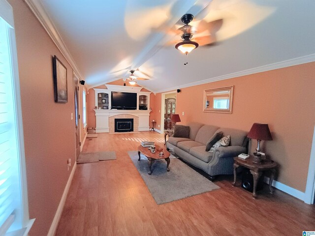 335 Shady Hollow Ln, Talladega, AL 35160 - living room featuring ceiling fan, a fireplace, baseboards, wood finished floors, and lofted ceiling