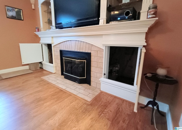 335 Shady Hollow Ln, Talladega, AL 35160 - detailed view of wood finished floors, a fireplace, and baseboards