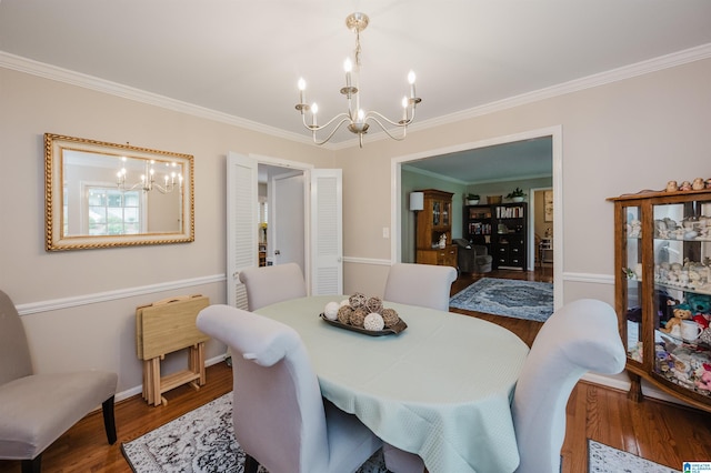 3309 Eaton Rd, Mountain Brook, AL 35223 - dining area featuring a chandelier, wood finished floors, ornamental molding, and baseboards