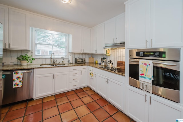 3309 Eaton Rd, Mountain Brook, AL 35223 - kitchen with a sink, appliances with stainless steel finishes, decorative backsplash, white cabinets, and under cabinet range hood