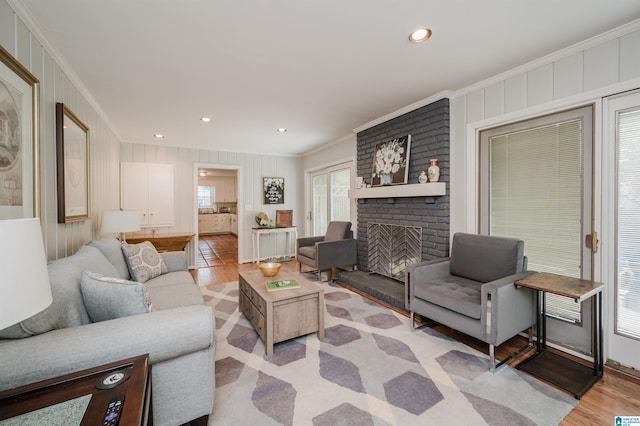 3309 Eaton Rd, Mountain Brook, AL 35223 - living area featuring ornamental molding, light wood-style flooring, a brick fireplace, and recessed lighting