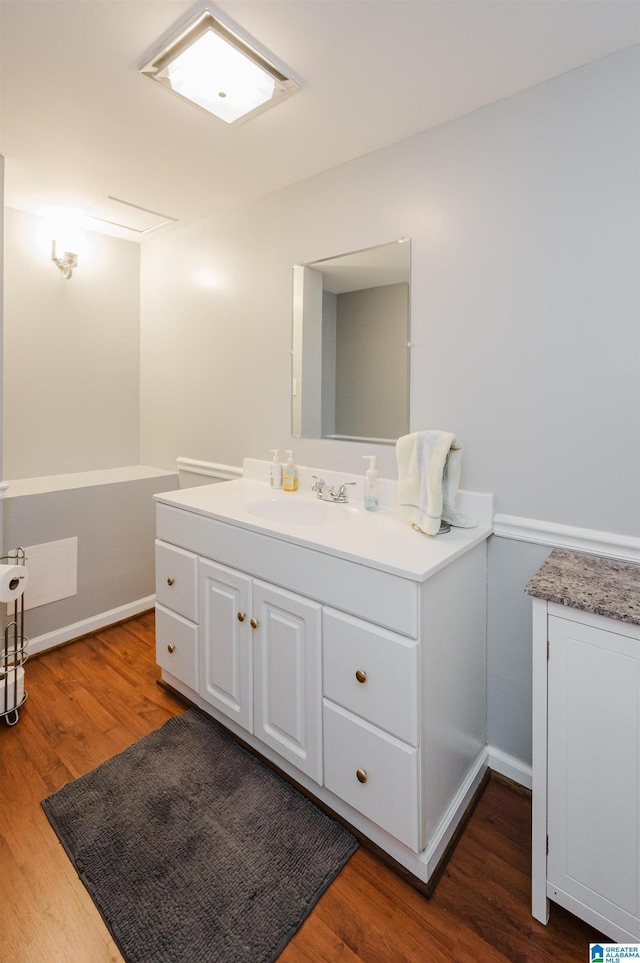 3309 Eaton Rd, Mountain Brook, AL 35223 - bathroom featuring vanity, wood finished floors, and baseboards
