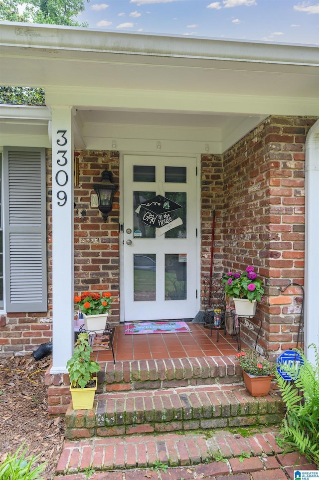 3309 Eaton Rd, Mountain Brook, AL 35223 - doorway to property featuring brick siding and a porch