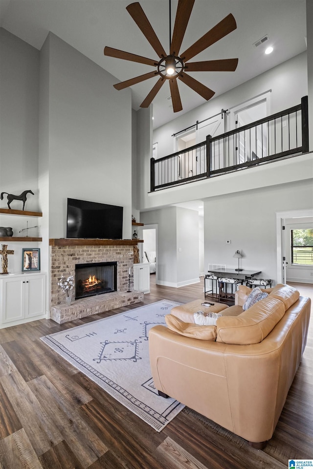 185 Meadowbrook Dr, Piedmont, AL 36272 - living room with ceiling fan, a high ceiling, a fireplace, wood finished floors, and recessed lighting