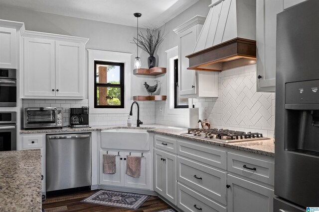185 Meadowbrook Dr, Piedmont, AL 36272 - kitchen with stainless steel appliances, premium range hood, a sink, white cabinets, and backsplash