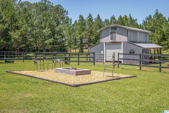185 Meadowbrook Dr, Piedmont, AL 36272 - exterior space featuring a garage, an outdoor structure, view of scattered trees, and an outbuilding