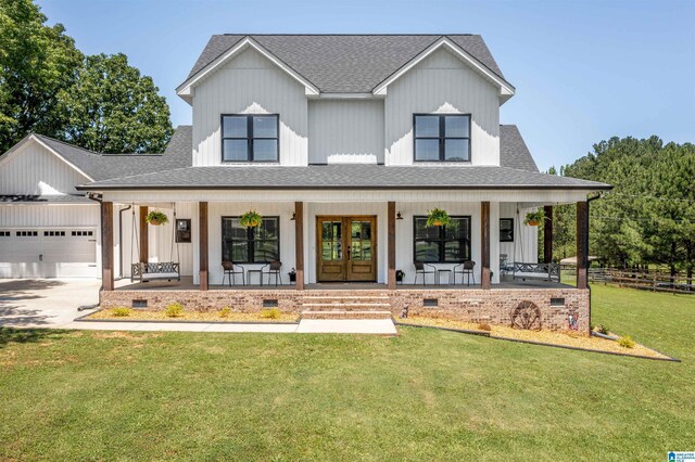 185 Meadowbrook Dr, Piedmont, AL 36272 - modern inspired farmhouse with covered porch, an attached garage, roof with shingles, and french doors