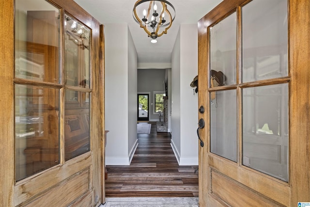 185 Meadowbrook Dr, Piedmont, AL 36272 - corridor with dark wood-type flooring, baseboards, and a chandelier