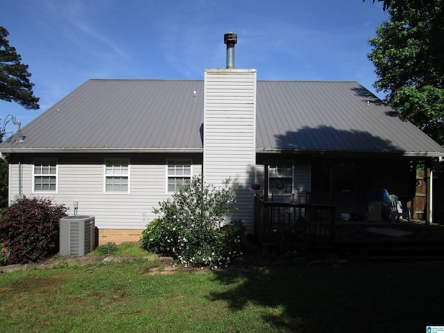 4634 Honeysuckle Rd, Quinton, AL 35130 - view of home's exterior with central air condition unit, metal roof, a chimney, and a yard