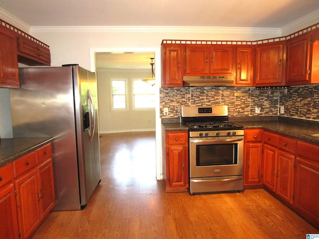 4634 Honeysuckle Rd, Quinton, AL 35130 - kitchen with appliances with stainless steel finishes, under cabinet range hood, ornamental molding, dark countertops, and light wood-type flooring