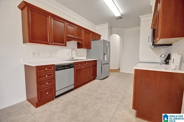 653 Talon Trce, Birmingham, AL 35242 - kitchen with stainless steel appliances, a sink, arched walkways, ornamental molding, and light tile patterned flooring