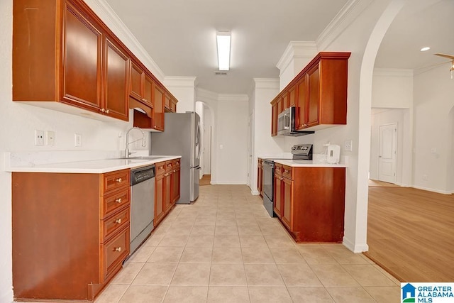 653 Talon Trce, Birmingham, AL 35242 - kitchen with appliances with stainless steel finishes, a sink, arched walkways, ornamental molding, and baseboards