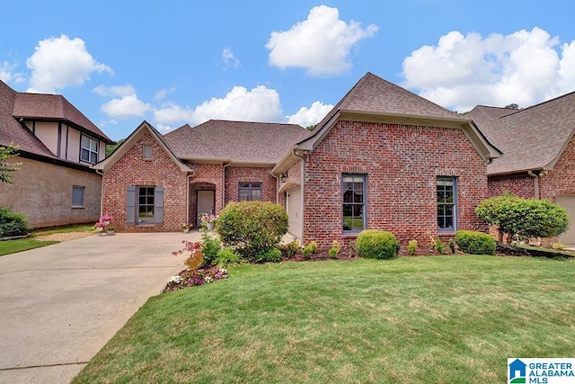 653 Talon Trce, Birmingham, AL 35242 - view of front facade featuring brick siding, concrete driveway, a front yard, a shingled roof, and a garage