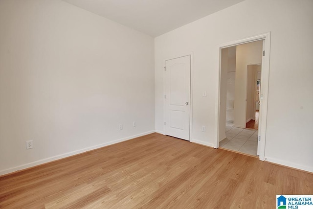 653 Talon Trce, Birmingham, AL 35242 - unfurnished bedroom with light wood-style flooring, baseboards, and ensuite bathroom