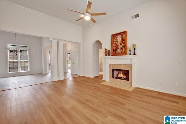 653 Talon Trce, Birmingham, AL 35242 - unfurnished living room featuring healthy amount of natural light, a ceiling fan, light wood-style flooring, arched walkways, and ornamental molding