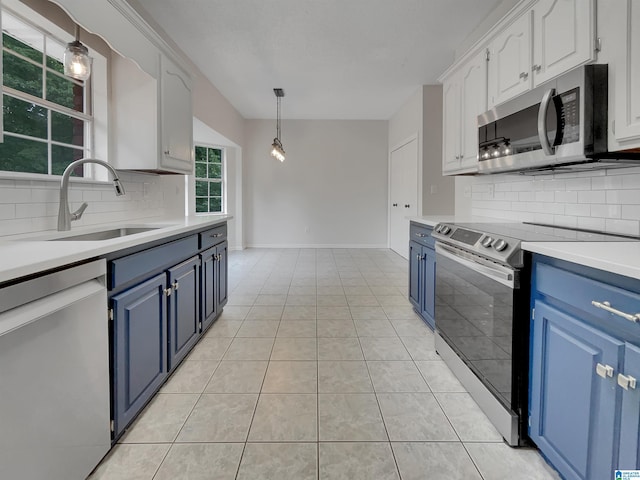 806 14th Ave, Pleasant Grove, AL 35127 - kitchen with stainless steel appliances, blue cabinets, a sink, backsplash, and light countertops