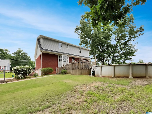 806 14th Ave, Pleasant Grove, AL 35127 - back of house featuring brick siding, a yard, an outdoor pool, and a wooden deck