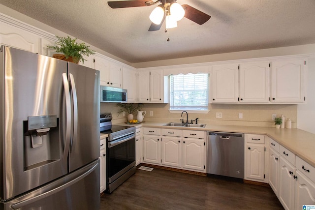 1725 Faircrest Dr, Hueytown, AL 35023 - kitchen featuring appliances with stainless steel finishes, a sink, dark wood finished floors, white cabinetry, and ceiling fan