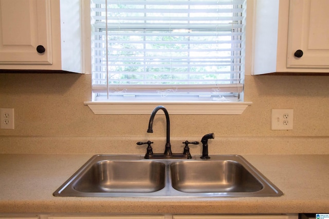1725 Faircrest Dr, Hueytown, AL 35023 - kitchen view of a sink, white cabinets, and light countertops