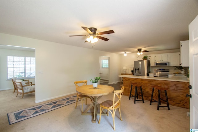 1725 Faircrest Dr, Hueytown, AL 35023 - dining area featuring a ceiling fan, light carpet, and baseboards