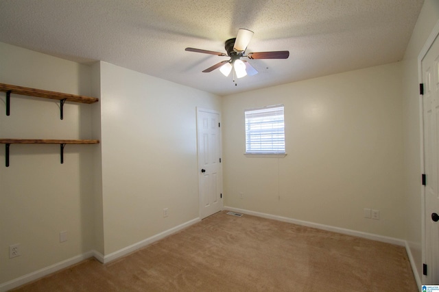 1725 Faircrest Dr, Hueytown, AL 35023 - unfurnished bedroom featuring light carpet, baseboards, ceiling fan, and a textured ceiling